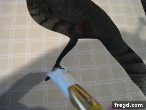 Another perspective of a stencil being applied to a charger plate, demonstrating careful alignment and adhesion