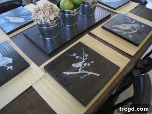 A finished DIY stenciled charger plate with a subtle, distressed bird design, ready for display