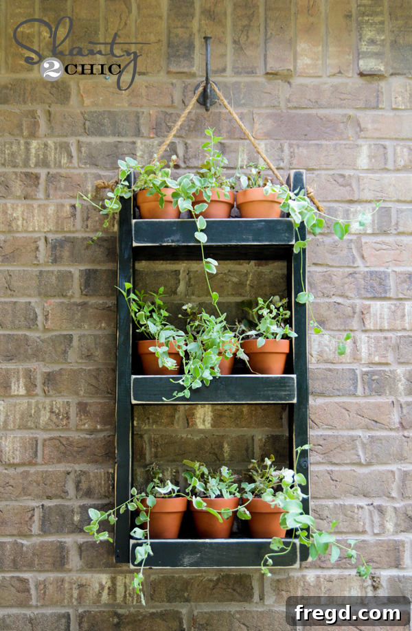 DIY One Hour Wood Wall Planter 2 Finished DIY Wood Wall Planter with vibrant green plants and terracotta pots, hanging on a brick wall, showcasing its rustic charm.