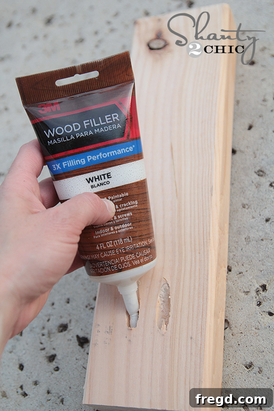 DIY One Hour Wood Wall Planter 10 Sanding the filled and assembled planter frame for a smooth finish before painting.