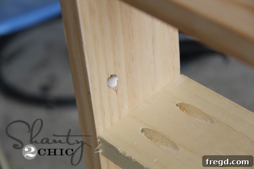 Applying Dowel Glue Applying wood glue inside dowel holes before insertion