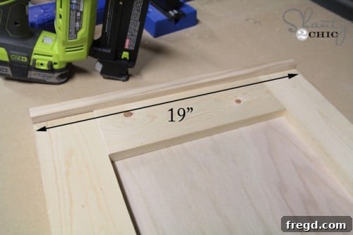 Attaching a trim piece to the mirror frame