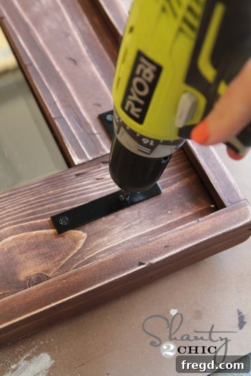 Metal hardware attached to the mirror frame