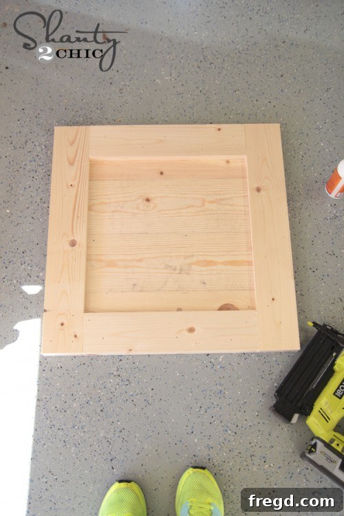 Nailing top and bottom 1x4 frame pieces to complete the wood sign structure