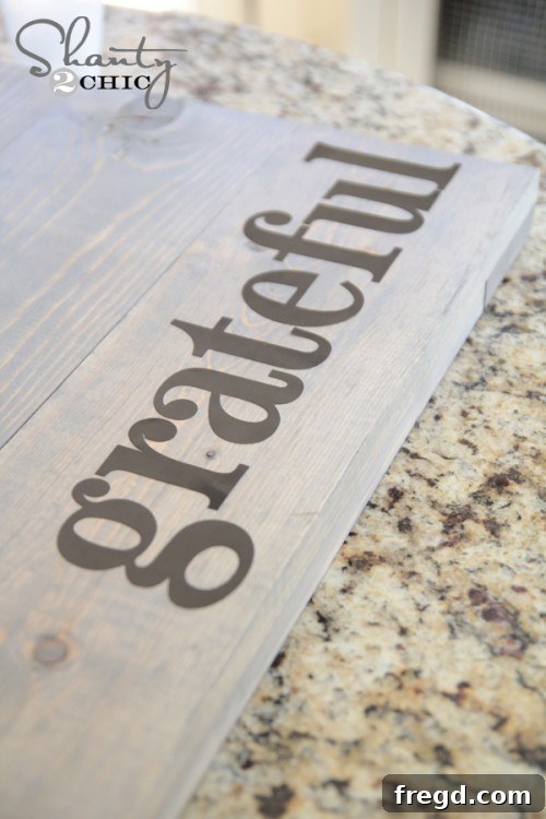 Placing 'Grateful' stencil letters accurately onto the stained wood sign