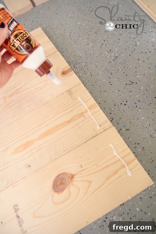 Applying wood glue along edges to join main sign panels