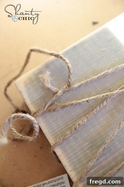 Securing the end of the jute twine with a staple on the wood block