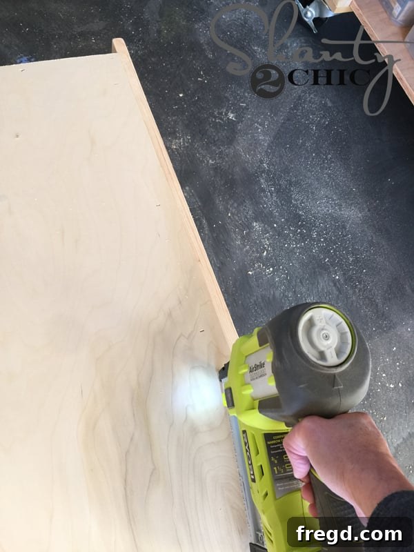 Attaching the back panel to the cabinet with staples