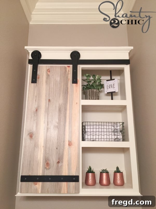 Barn Door Storage Cabinet adding farmhouse charm to bathroom