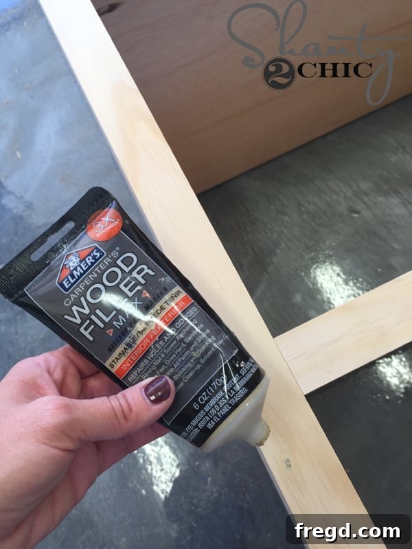 Optimizing My Sliding Barn Door Media Console with Custom Shelving 23 Applying Wood Filler to Nail Holes