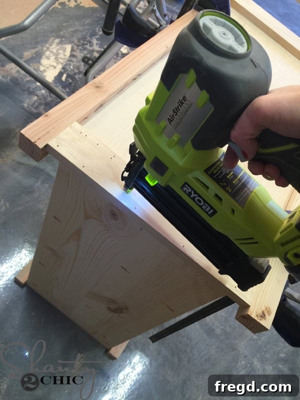 Attaching ladder to cabinet with brad nailer