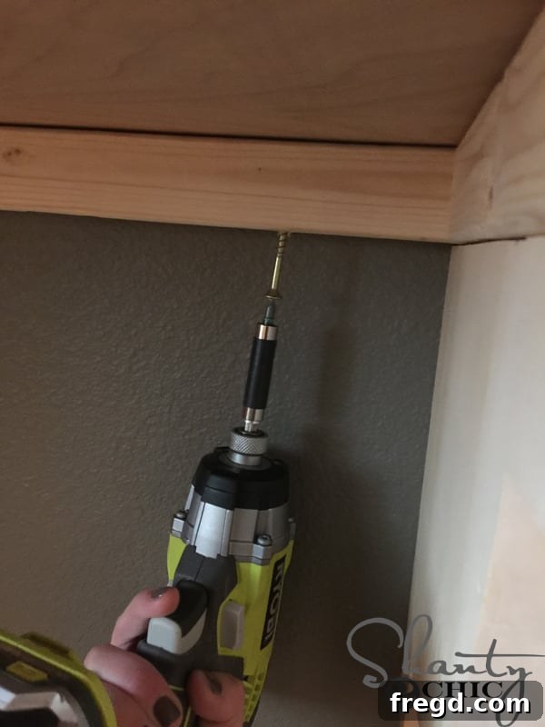 Adding screws to the back edge of the desk top for stability