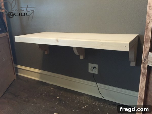 Floating desk with top and trim attached, ready for finish
