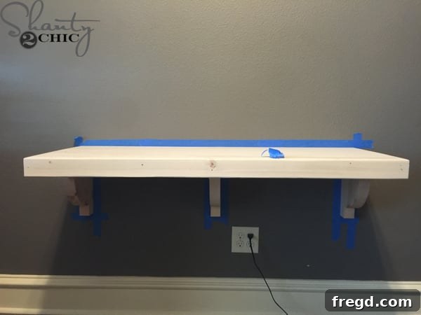Taping off the wall around the desk for staining