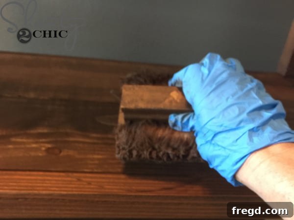 Applying Varathane Early American stain to the desk