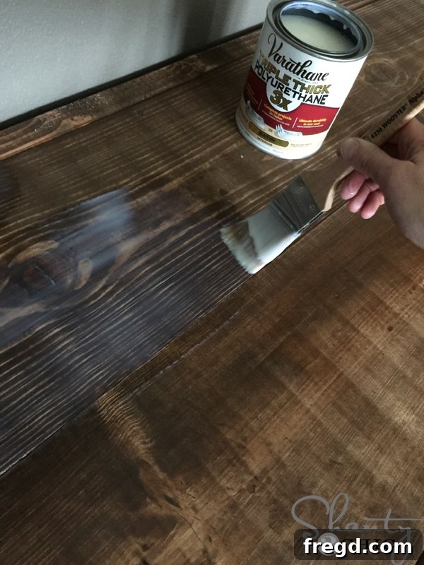 Applying Varathane Triple Thick polyurethane to the desk