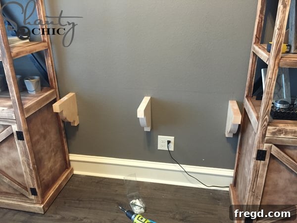 Attaching corbels to the wall to support the floating desk