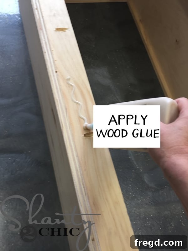 Applying wood glue to back braces of locker