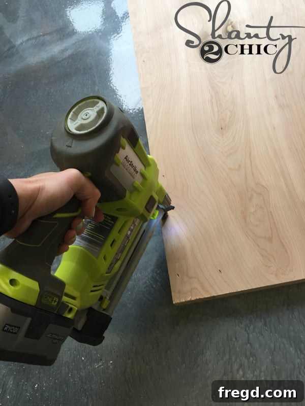Attaching 1/4-inch plywood panel to door frame with staples