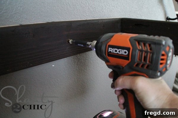 Attaching the main wall cleat piece to the wall studs