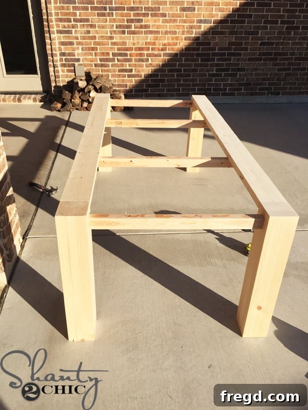 DIY Modern Open Concept Farmhouse Table HGTV Style 14 Table with outside planks attached, showing progress
