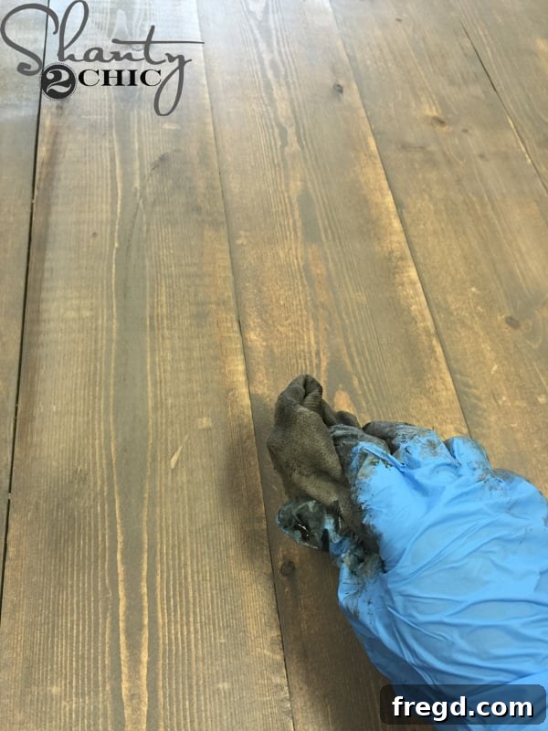 DIY Modern Open Concept Farmhouse Table HGTV Style 16 Applying custom mixed stain to the modern farmhouse table