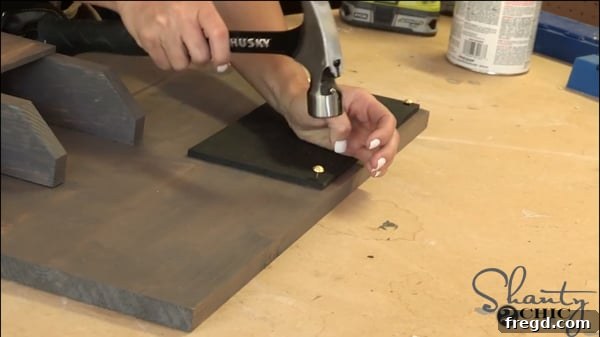Spray painting the 5.5-inch wide luan board with Rust-Oleum Chalkboard paint