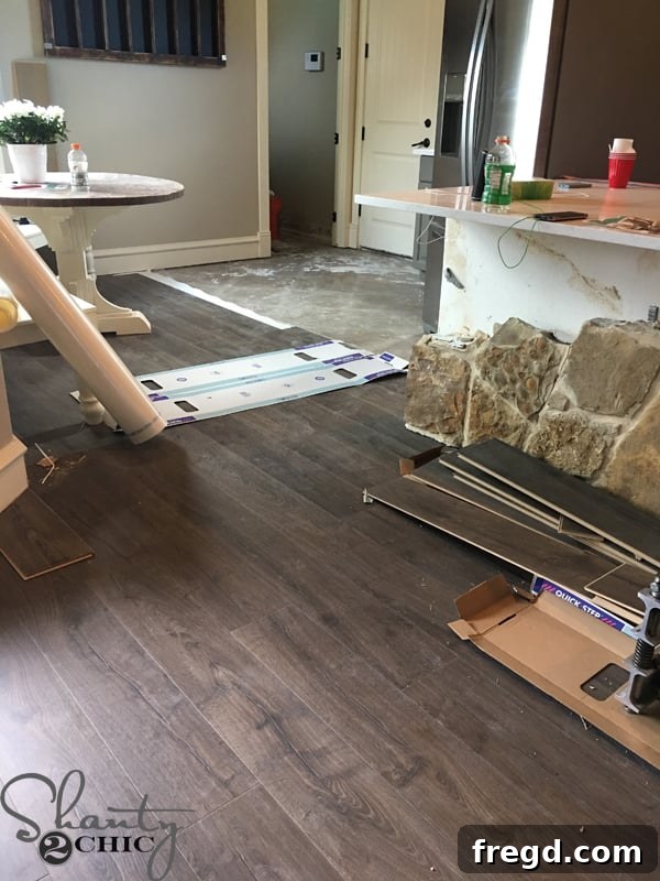 My Kitchen's Laminate Makeover 6 Laminate flooring installation in progress, showing new planks being laid.