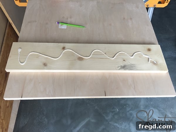 Rustic Glide Media Hub 21 applying-wood-glue-to-barn-door-trim