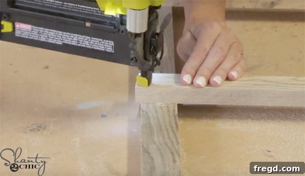 Assembling the blanket ladder frame using a brad nailer, showing rung attachment