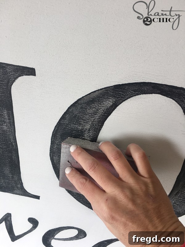 Attaching the stained frame to the painted sign.