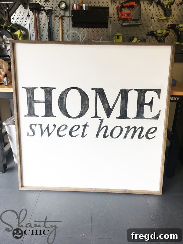 Distressing the painted letters with a sanding pad.
