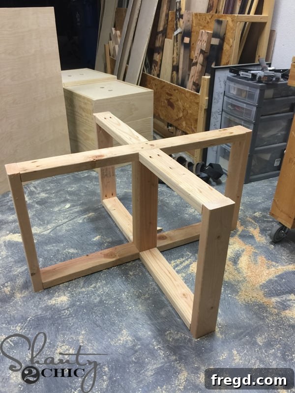 Build Your Own Rolling Storage Ottoman Coffee Table 22 A wooden plank being installed as a center support to the already assembled coffee table base frame, secured with screws.