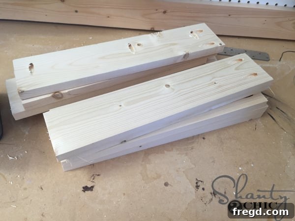 Build Your Own Rolling Storage Ottoman Coffee Table 5 Close-up of a wood piece with multiple 3/4-inch pocket holes drilled using a Kreg Jig, demonstrating precise and clean joinery preparation.