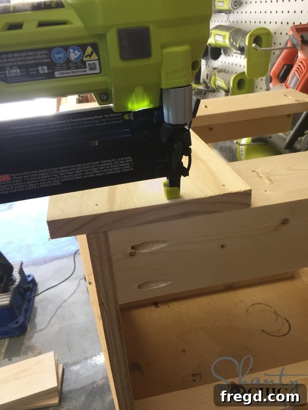 Build Your Own Rolling Storage Ottoman Coffee Table 10 Attaching the initial side planks to an ottoman frame, demonstrating the precise overhang at the bottom to conceal casters.