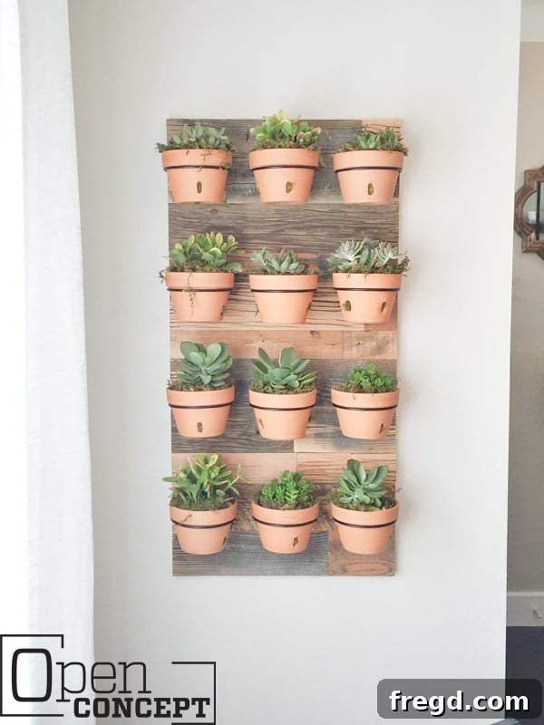 Stunning DIY Barnwood Herringbone Accent Wall 6 A stylish reclaimed wood wall planter filled with greenery, demonstrating an innovative use of barn wood for vertical gardening.