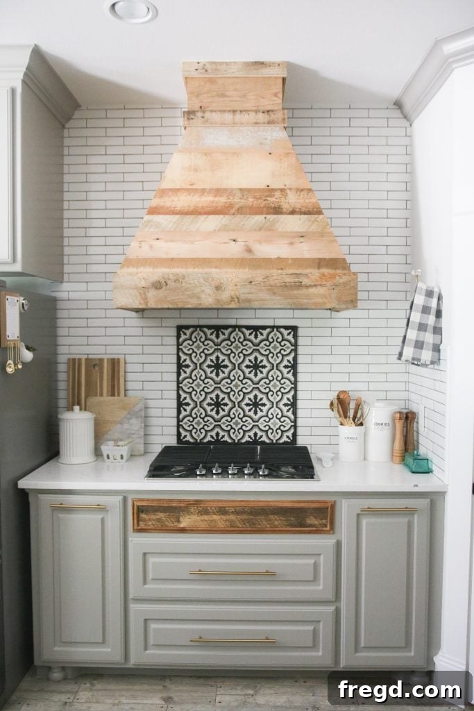 Stunning DIY Barnwood Herringbone Accent Wall 8 A custom DIY vent hood crafted from reclaimed barn wood, adding a rustic and unique focal point to a modern kitchen.