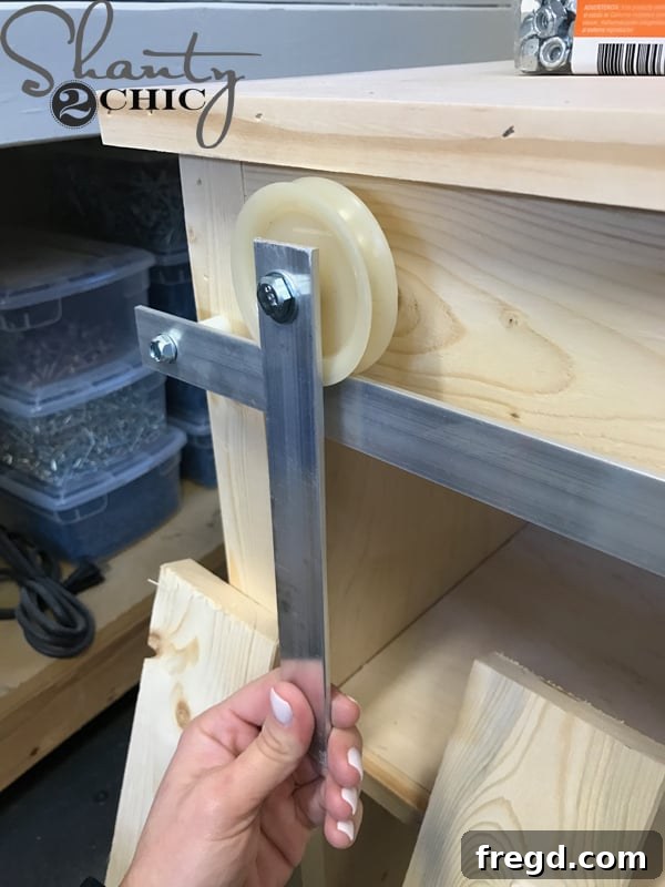 Make Your Own Barn Door Hardware for Just $20 17 Barn door track attached to furniture
