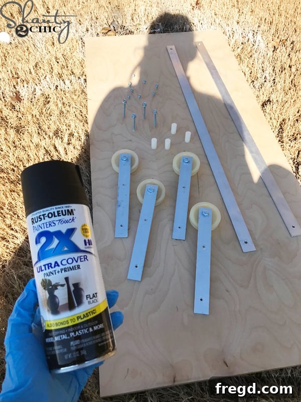 Make Your Own Barn Door Hardware for Just $20 18 Testing the fit of the DIY barn door hardware before painting
