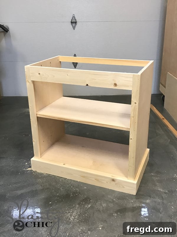 Craft Your Own Sliding Barn Door Nightstand 19 Attaching the front base trim to the nightstand, completing the base