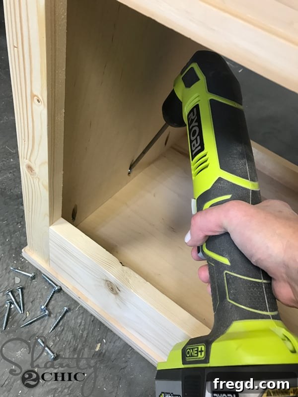 Craft Your Own Sliding Barn Door Nightstand 20 Nightstand frame upside down on the top piece, preparing for attachment