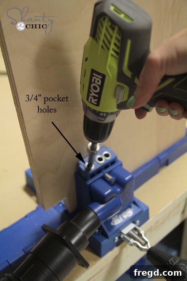 Craft Your Own Sliding Barn Door Nightstand 4 Demonstration of drilling pocket holes into plywood for nightstand assembly