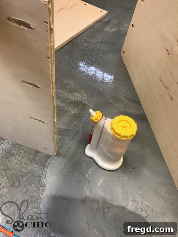 Craft Your Own Sliding Barn Door Nightstand 7 Applying wood glue using a GlueBot for precise and mess-free application