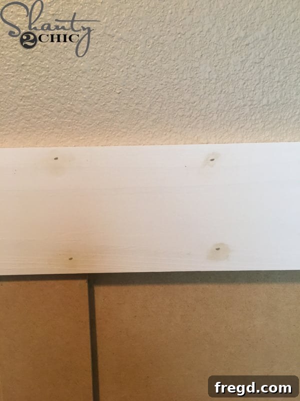 Ultimate Laundry Room Makeover 12 Installing the 1x4 primed MDF top trim piece