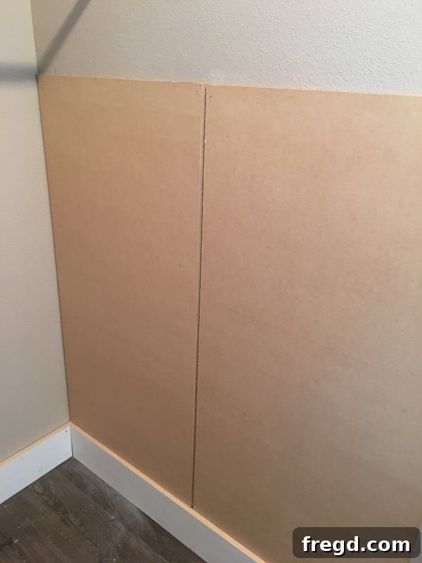 Ultimate Laundry Room Makeover 9 Using a Ryobi stapler to attach MDF panels to the wall