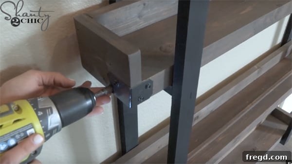 Kitchen Upgrade: DIY Floating Dish Shelf Tutorial 28 Securing each shelf to the rungs from underneath with wood screws