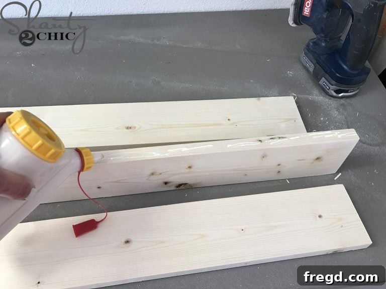Assembling the arm guide for the backrest of the DIY outdoor lounge chair, showing 1x2 pieces attached to a 1x4 with glue.