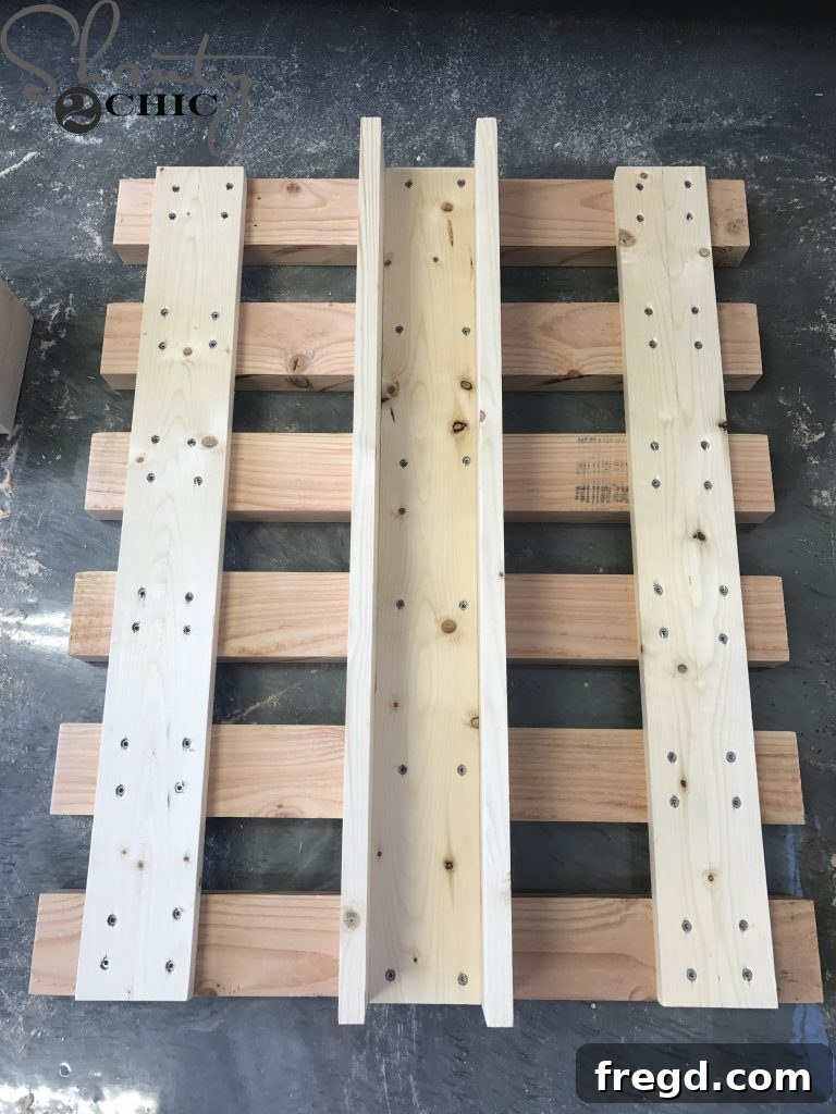 Attaching the arm guide to the back slats of the lounge chair with wood glue and screws, a crucial step for the adjustable backrest mechanism.