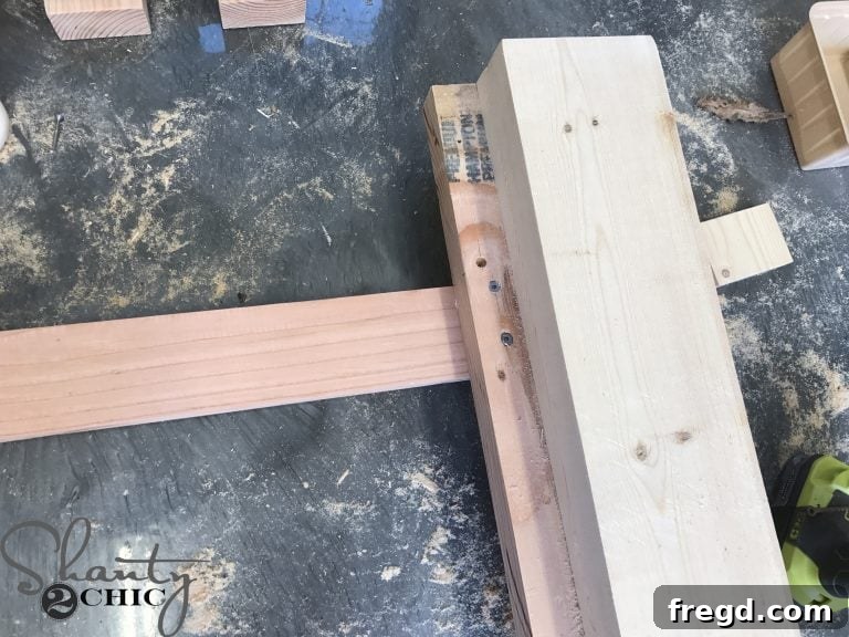 Installing the remaining slat underneath the cleats with screws and glue, forming a crucial hinge board for the adjustable backrest of the lounge chair.