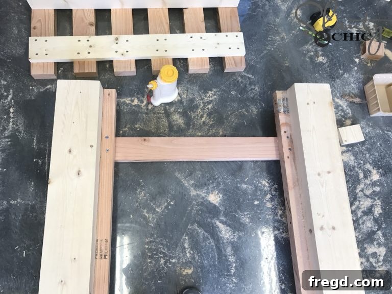 Close-up of the hinge board formed by an attached slat under the cleats, ready for the piano hinge installation on the DIY lounge chair.
